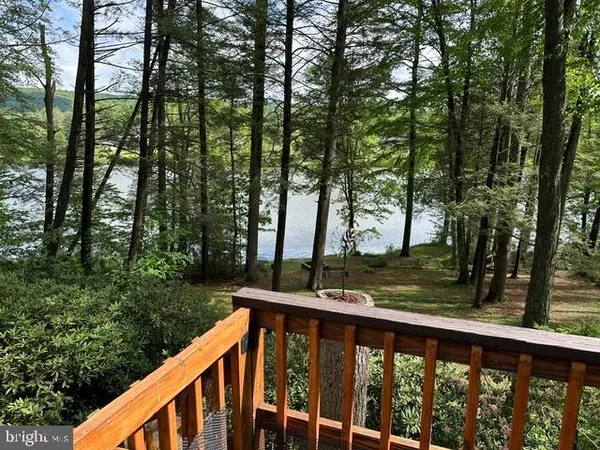 an aerial view of residential houses with outdoor space and ocean view