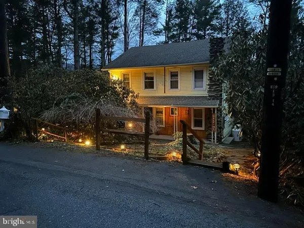 a view of empty room with wooden floor and fireplace