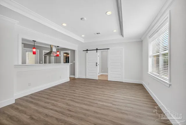 an empty room with windows and closet