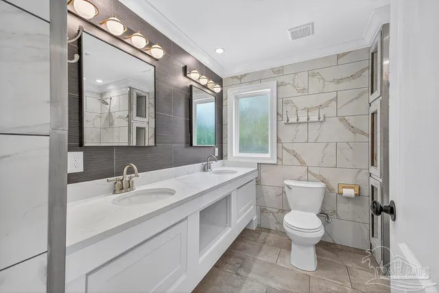 a house with green field in front of it