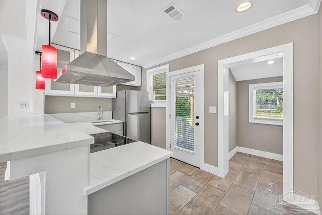a view of empty room with wooden floor and window
