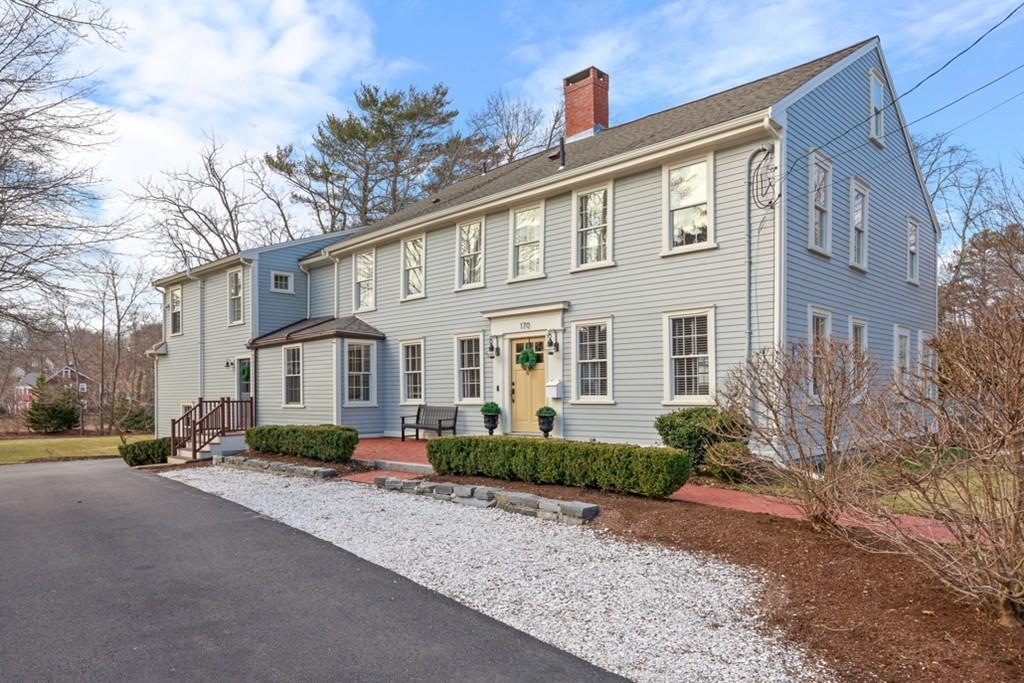 a front view of a house with a yard and outdoor seating