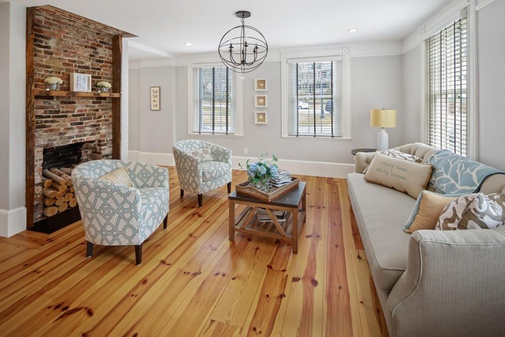170 North Street Hingham, MA 02043 - Photo 11 of 42 a living room with furniture dining table wooden floor and a fireplace