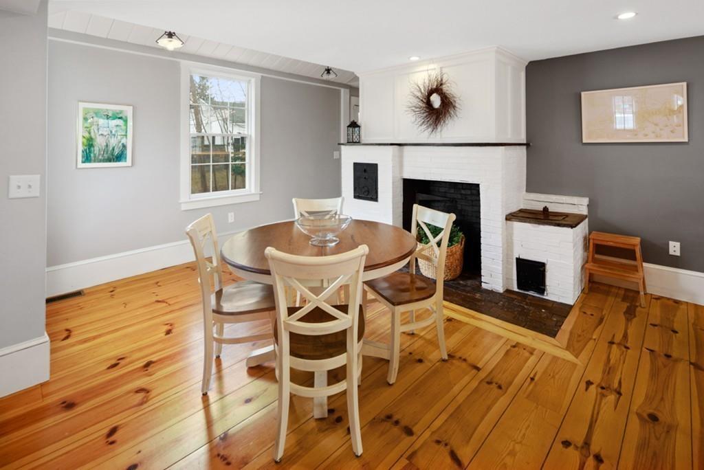 170 North Street Hingham, MA 02043 - Photo 7 of 42 a living room with a fireplace and a table
