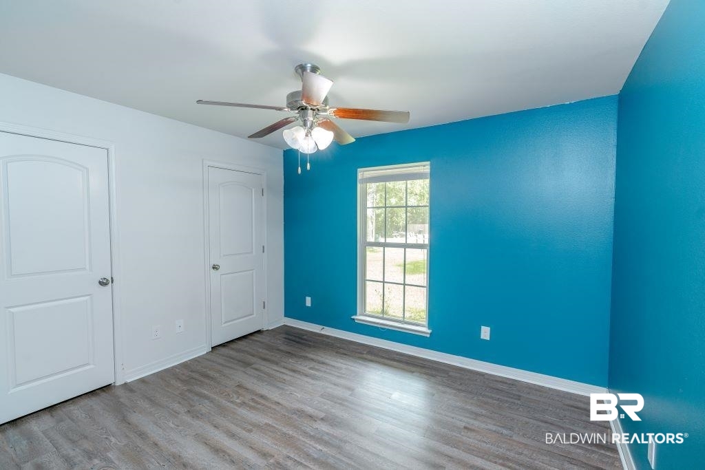 12641 Pecan Street Grand Bay, AL 36541 - Photo 16 of 23 Unfurnished bedroom with ceiling fan and wood-type flooring