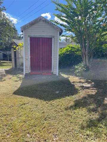 a view of a yard with wooden fence