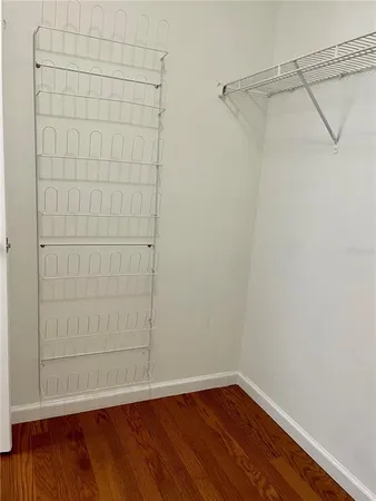 a view of a small space with wooden floor and small cabinets