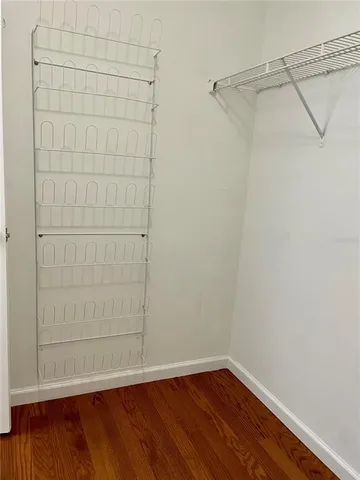 a view of a small space with wooden floor and small cabinets