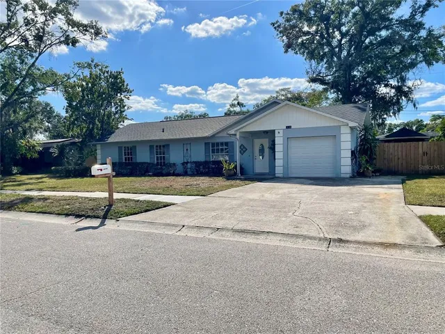 a white house with a large tree