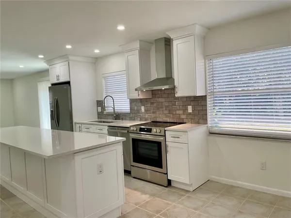a kitchen with a stove a sink and a refrigerator