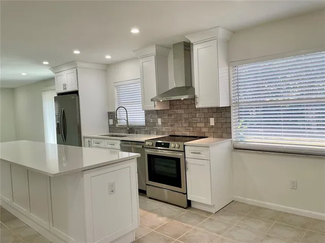 a kitchen with a stove a sink and a refrigerator