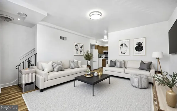 a living room with furniture and a view of bathroom