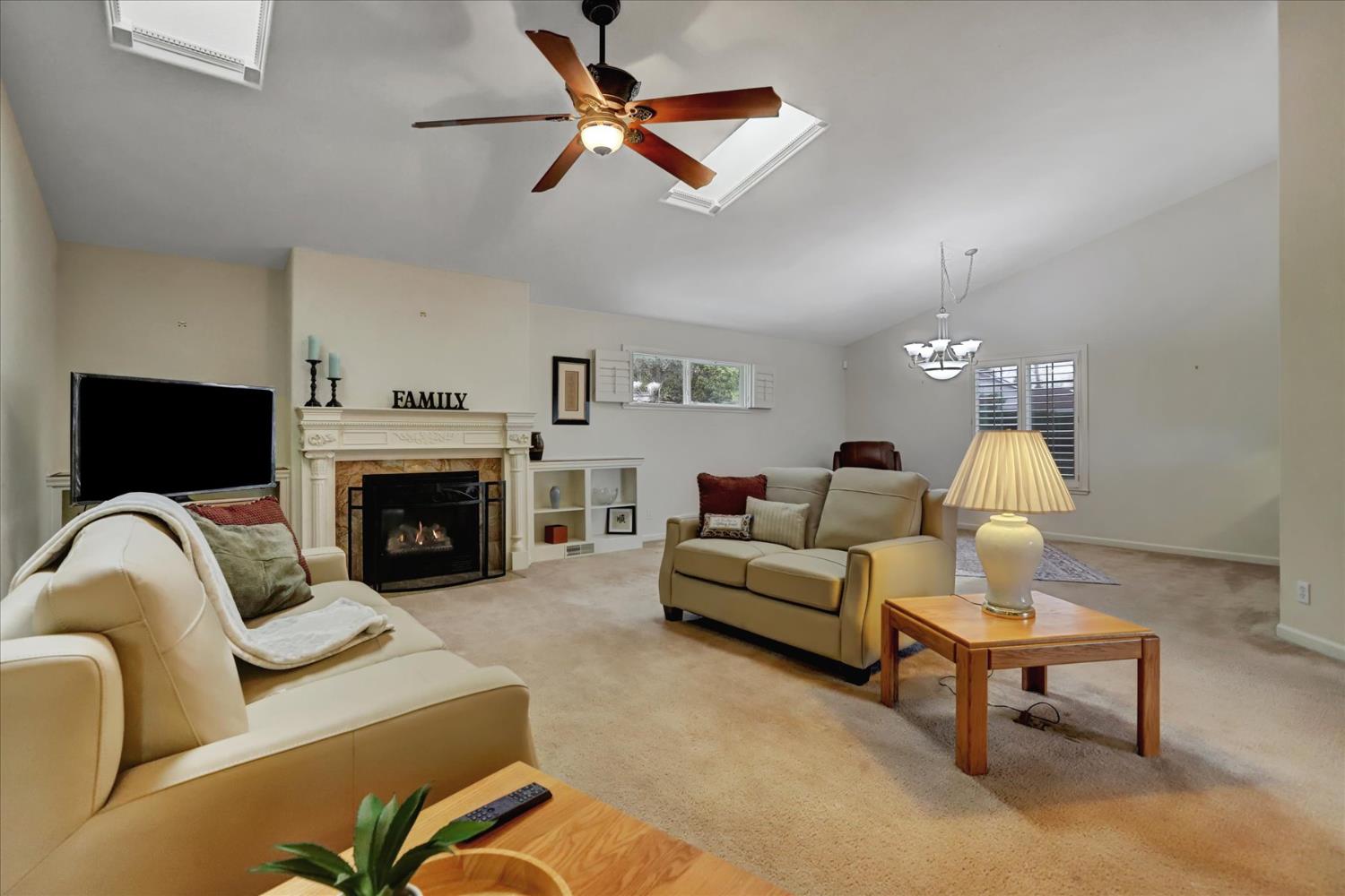 124 Ruby Ledge Court Grass Valley, CA 95945 - Photo 11 of 87 a living room with furniture a fireplace and a flat screen tv