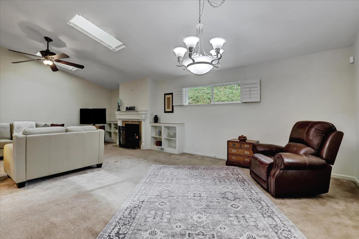 124 Ruby Ledge Court Grass Valley, CA 95945 - Photo 15 of 87 a view of a livingroom with furniture a chandelier a kitchen island with wooden floor and chandelier
