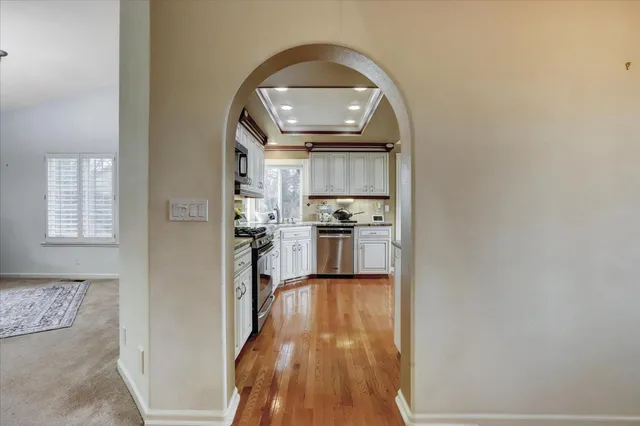 a kitchen with granite countertop a stove a sink and a microwave