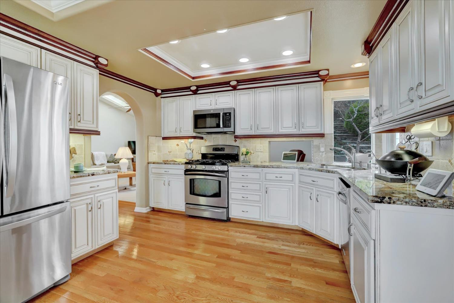 124 Ruby Ledge Court Grass Valley, CA 95945 - Photo 22 of 87 a kitchen with granite countertop a refrigerator stove top oven and sink