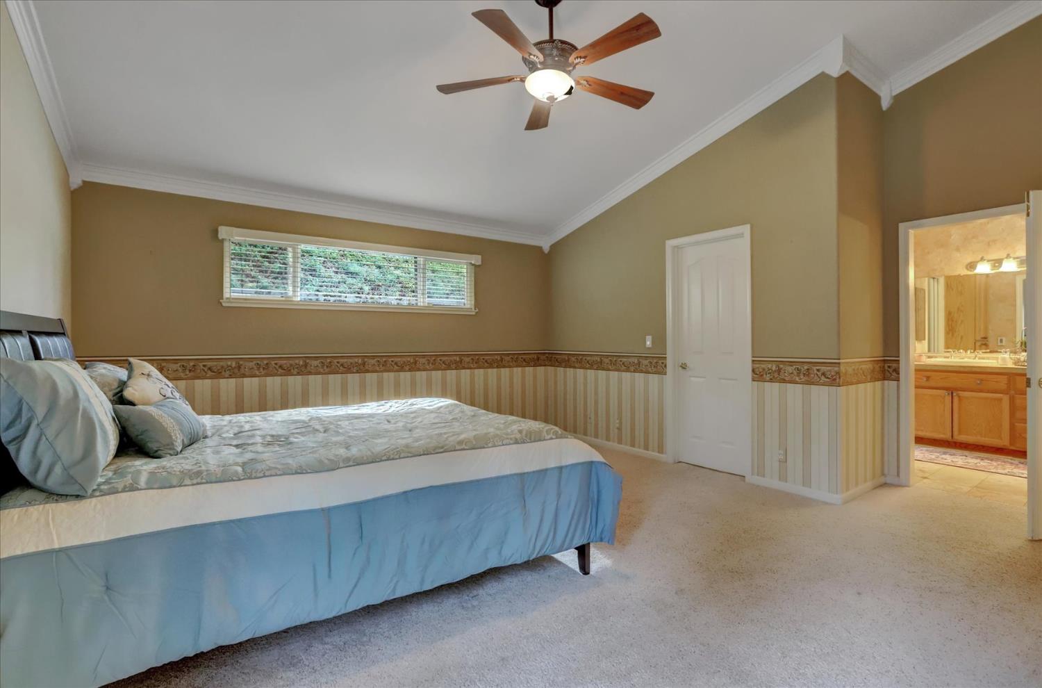 124 Ruby Ledge Court Grass Valley, CA 95945 - Photo 29 of 87 a bedroom with a bed and ceiling fan
