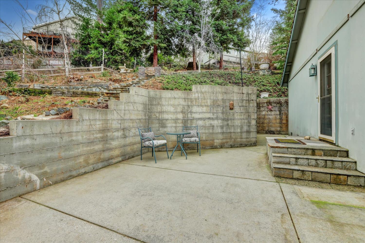 124 Ruby Ledge Court Grass Valley, CA 95945 - Photo 54 of 87 a backyard of a house with outdoor seating