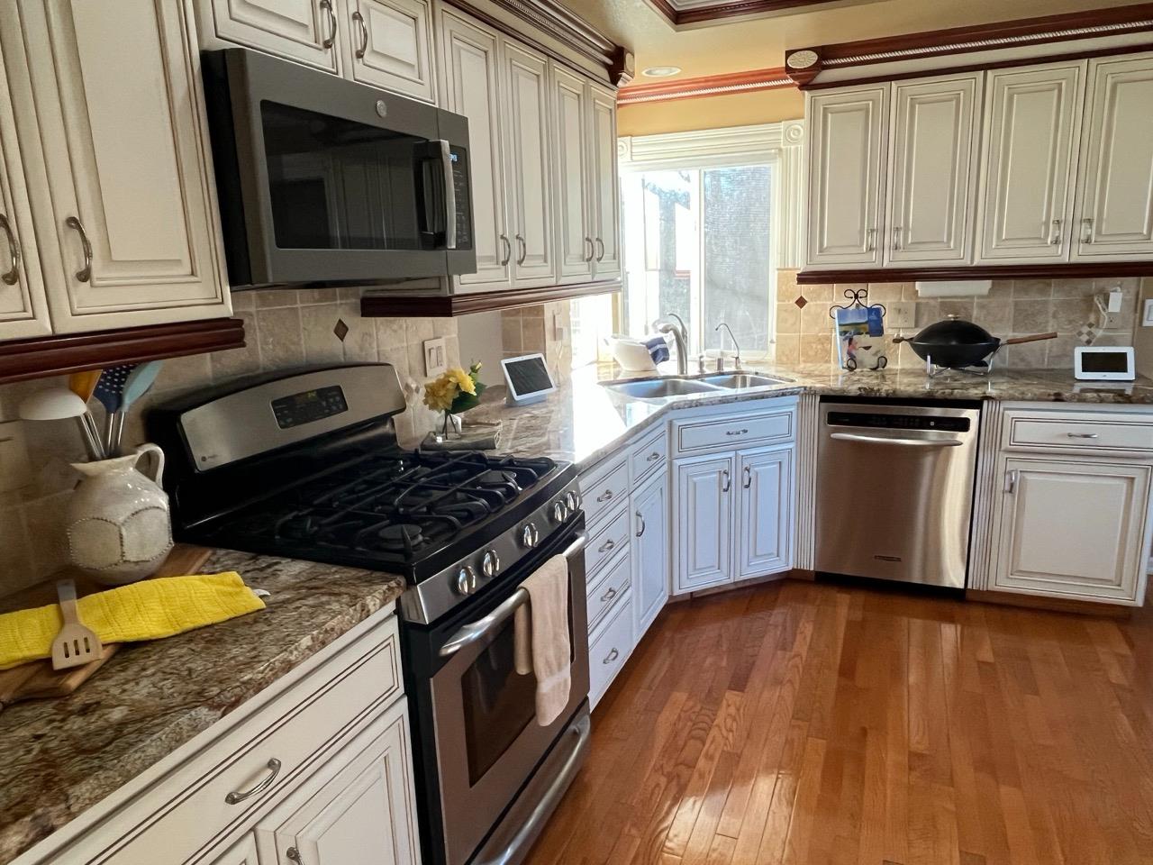 124 Ruby Ledge Court Grass Valley, CA 95945 - Photo 83 of 87 a kitchen with stainless steel appliances granite countertop a stove a sink and a microwave
