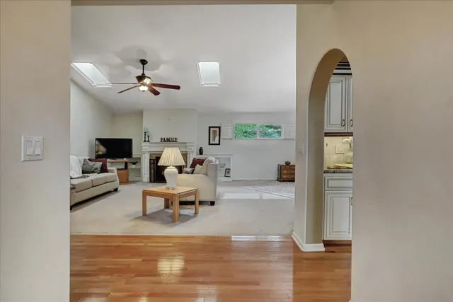 a living room with furniture and a chandelier
