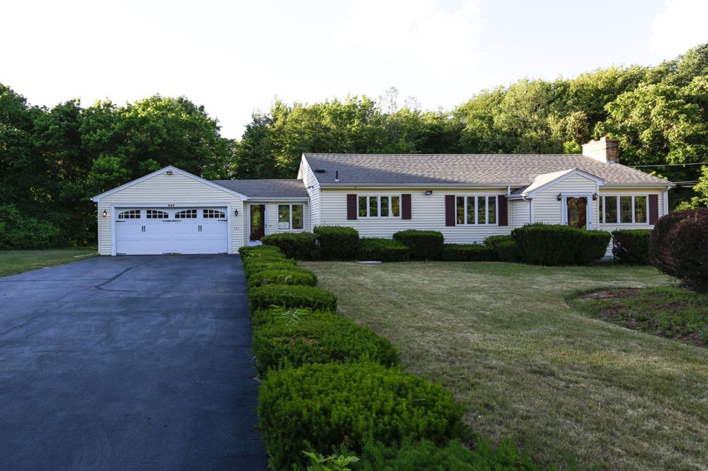 485 Rhodes Avenue Woonsocket, RI 02895 - Photo 1 of 18 a front view of a house with a garden and trees