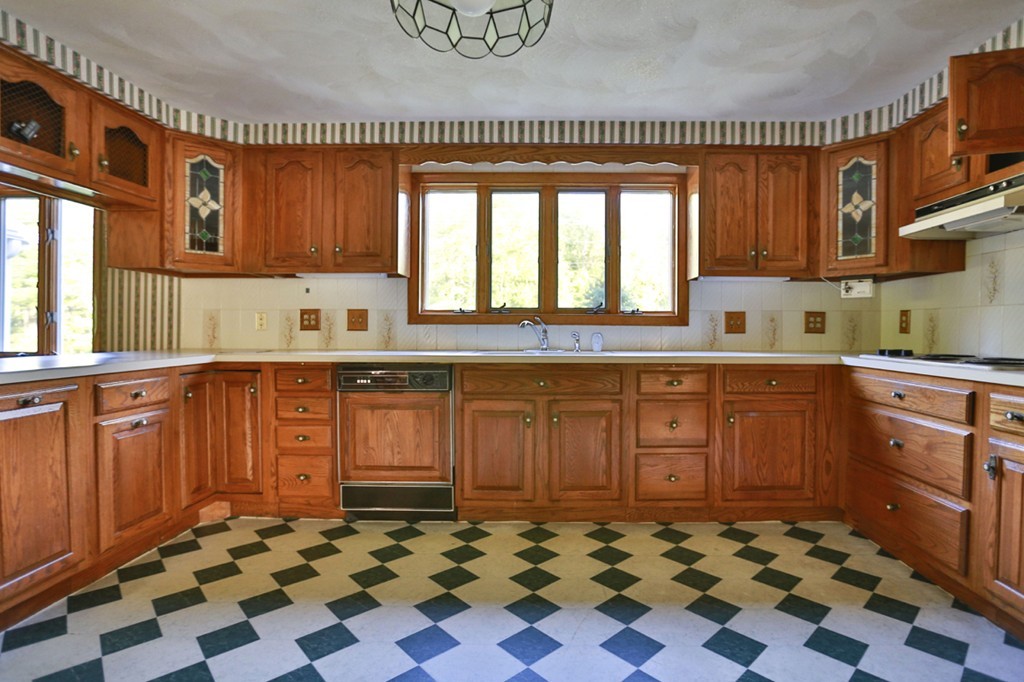 485 Rhodes Avenue Woonsocket, RI 02895 - Photo 6 of 18 a kitchen with stainless steel appliances a sink a stove a refrigerator and wooden cabinets