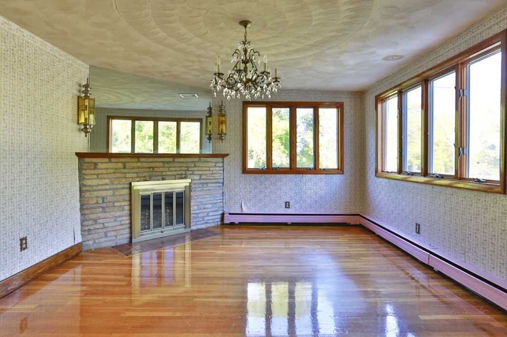 485 Rhodes Avenue Woonsocket, RI 02895 - Photo 8 of 18 a view of an empty room with a window and wooden floor