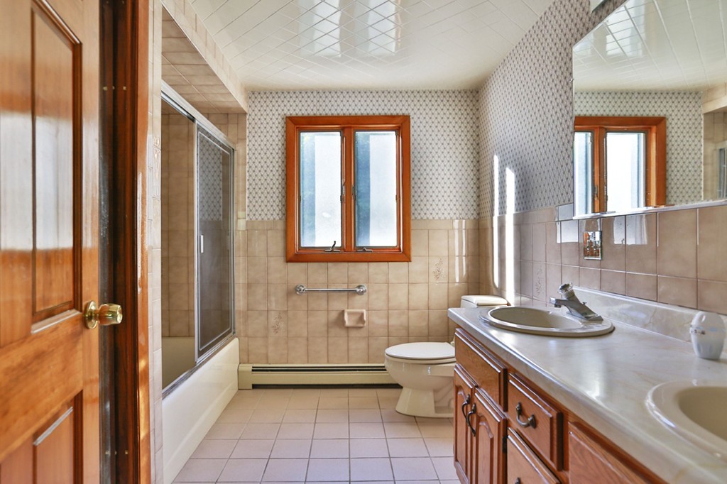 485 Rhodes Avenue Woonsocket, RI 02895 - Photo 9 of 18 a bathroom with a granite countertop sink a toilet and shower