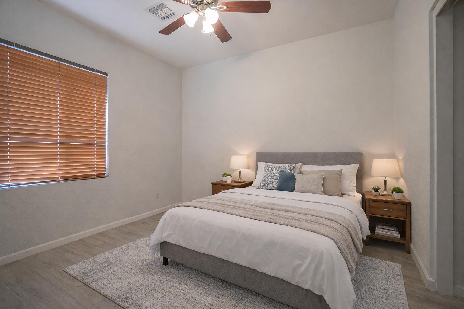 9377 West Milkweed Loop Phoenix, AZ 85037 - Photo 12 of 28 a bedroom with a bed and a chandelier