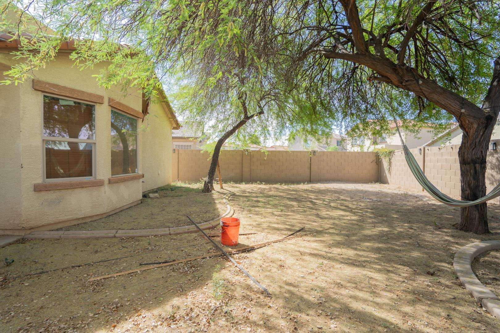 9377 West Milkweed Loop Phoenix, AZ 85037 - Photo 20 of 28 a backyard of a house with lots of green space