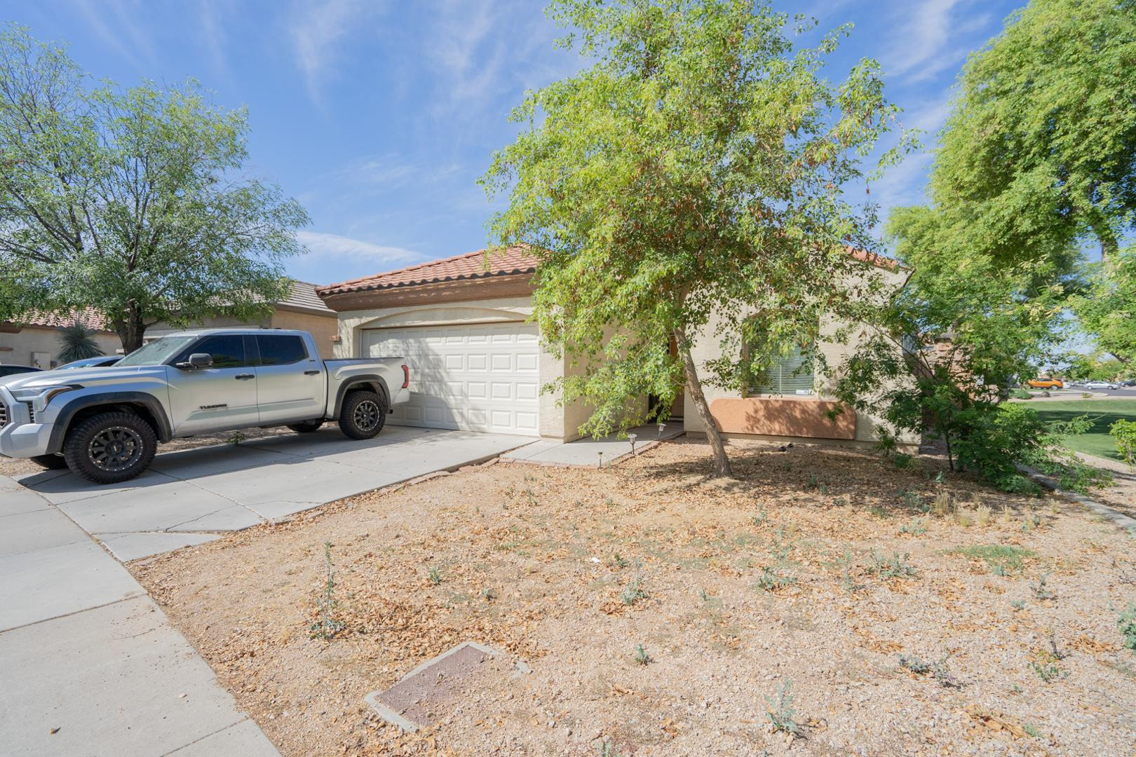 9377 West Milkweed Loop Phoenix, AZ 85037 - Photo 2 of 28 a view of a car parked in front of a house