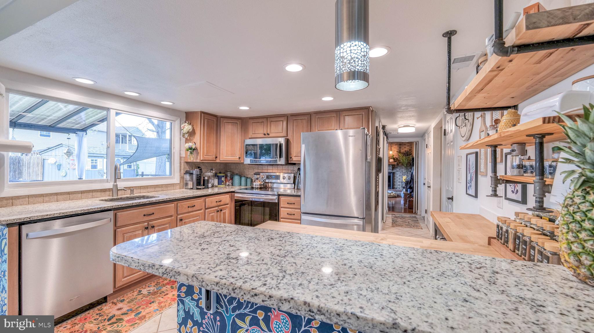 1 Chadwick Avenue Marlton, NJ 08053 - Photo 16 of 41 a kitchen with stainless steel appliances granite countertop a refrigerator a sink dishwasher a stove and a dining table with wooden floor