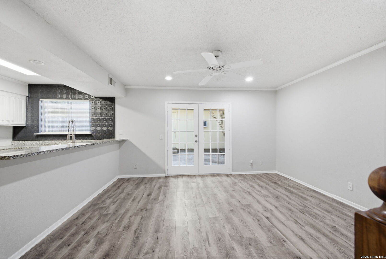6106 Vance Jackson Road, Unit 15 San Antonio, TX 78230 - Photo 9 of 30 an empty room with wooden floor and windows