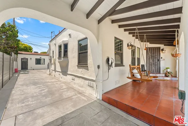 a view of a patio with table and chairs and potted plants
