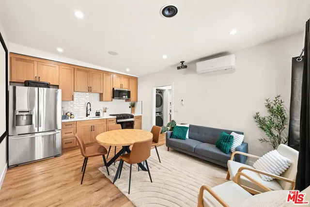 a living room with furniture and kitchen view