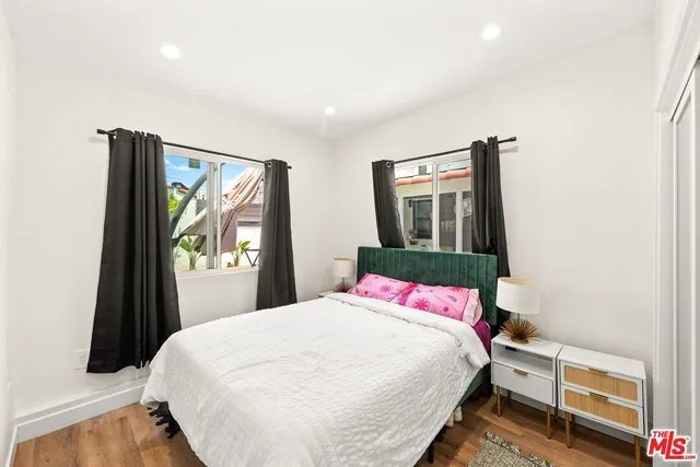 a bedroom with a bed and a painting on the wall