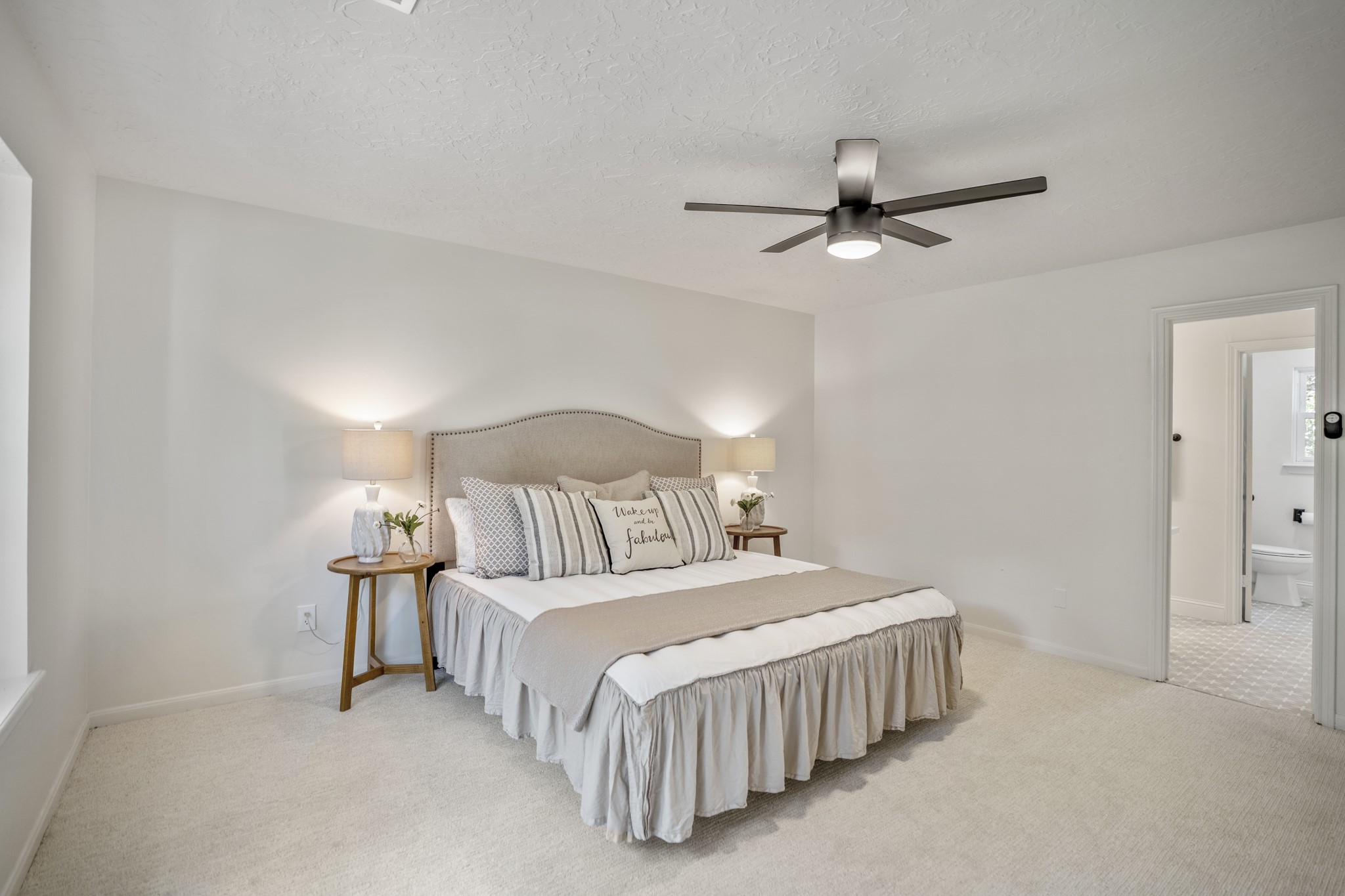 6303 Larkmount Drive Spring, TX 77389 - Photo 22 of 50 Stepping further into the primary suite, the connection to the updated ensuite bath comes into view just beyond the doorway. Soft natural light, fresh paint, and newer carpet keep the room feeling calm and refreshed, while the tucked-away location off the family room adds a nice sense of separation from the main living areas.