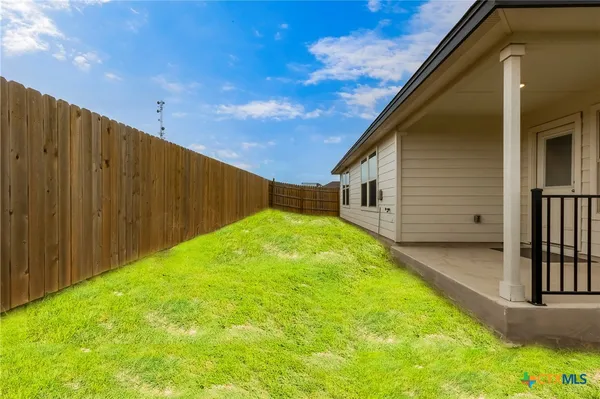 a backyard of a house with swimming pool in front of it