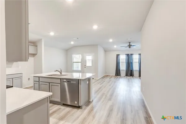 a large kitchen with kitchen island a sink stainless steel appliances and cabinets