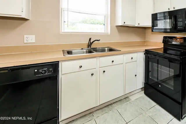 a kitchen with a sink and cabinets