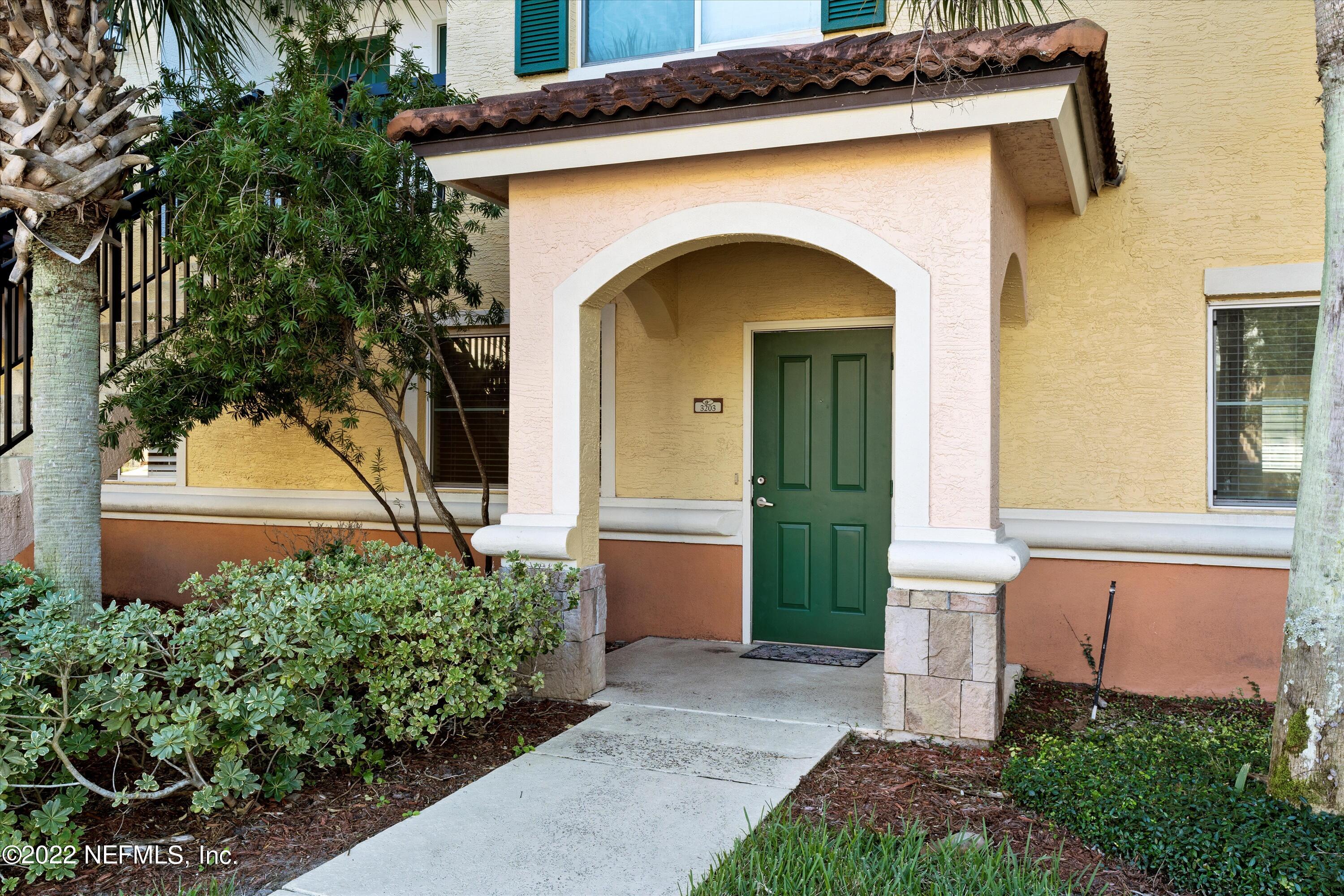 9745 Touchton Road, Unit 3203 Jacksonville, FL 32246 - Photo 1 of 30 a front view of a house with a yard