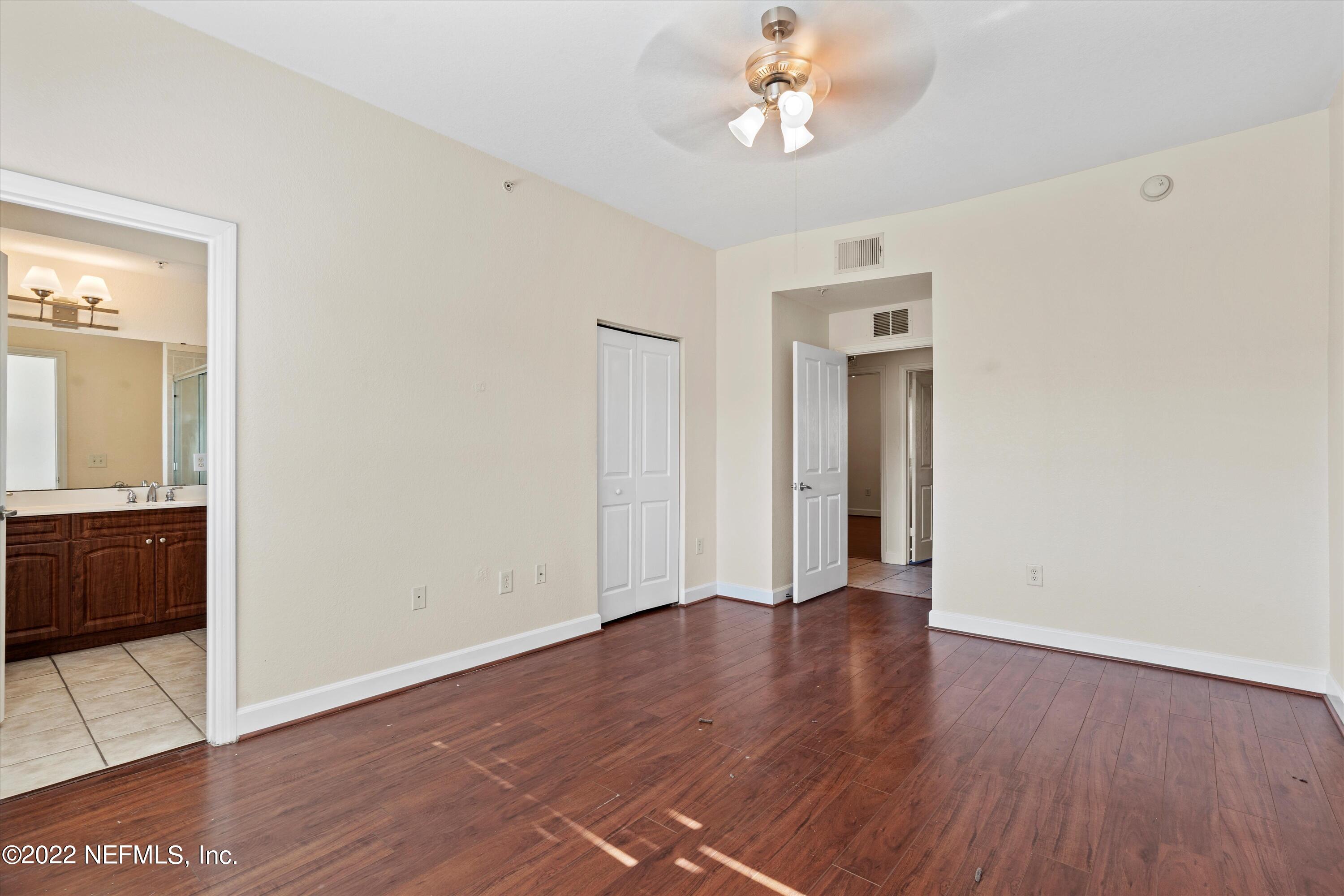 9745 Touchton Road, Unit 3203 Jacksonville, FL 32246 - Photo 11 of 30 an empty room with wooden floor and windows