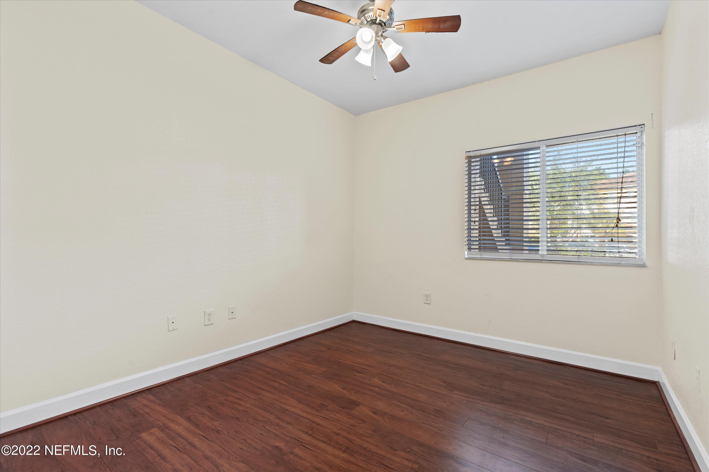 9745 Touchton Road, Unit 3203 Jacksonville, FL 32246 - Photo 15 of 30 wooden floor in an empty room with a window