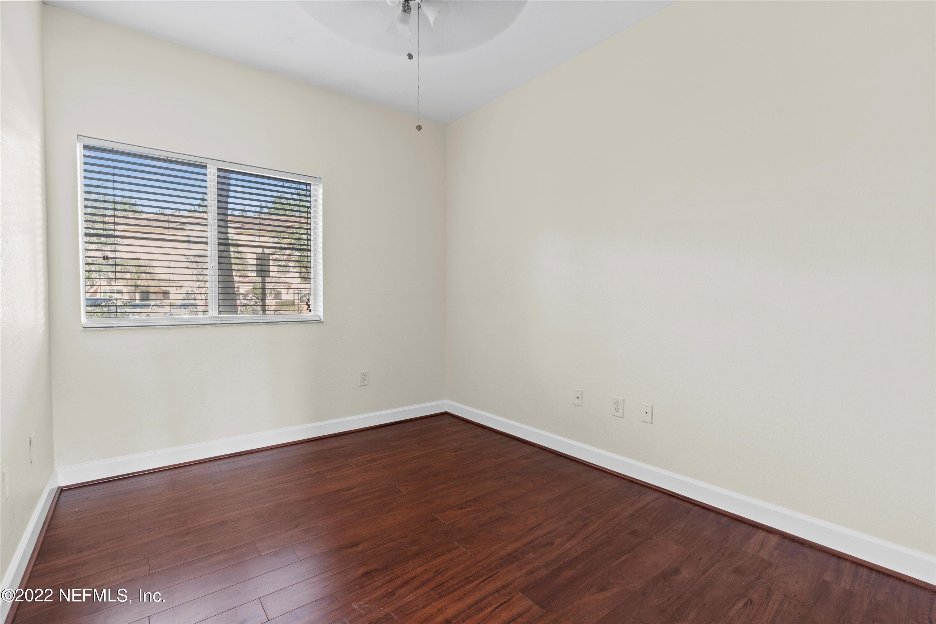 9745 Touchton Road, Unit 3203 Jacksonville, FL 32246 - Photo 16 of 30 an empty room with wooden floor and windows