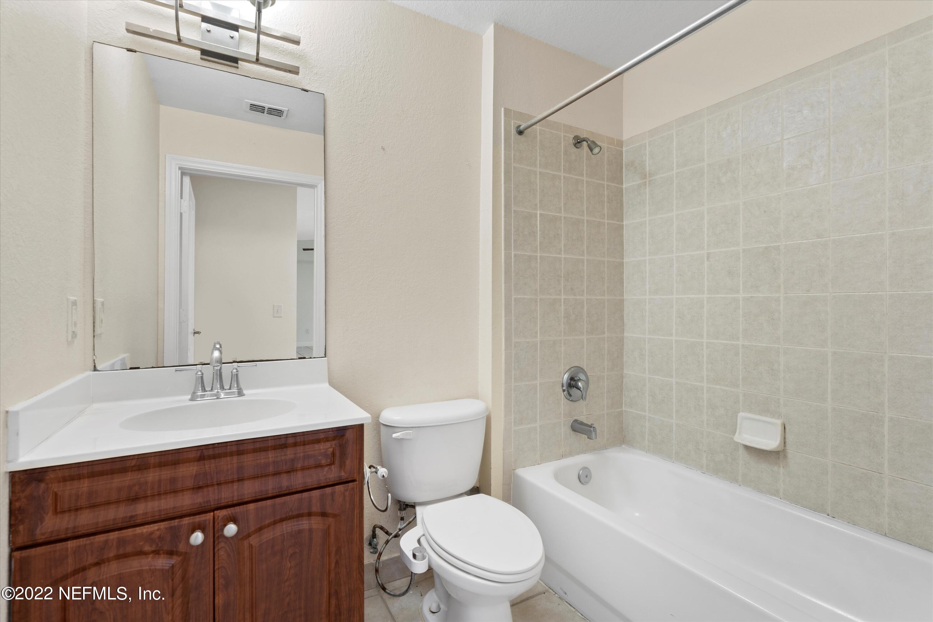 9745 Touchton Road, Unit 3203 Jacksonville, FL 32246 - Photo 19 of 30 a bathroom with a sink a toilet and shower