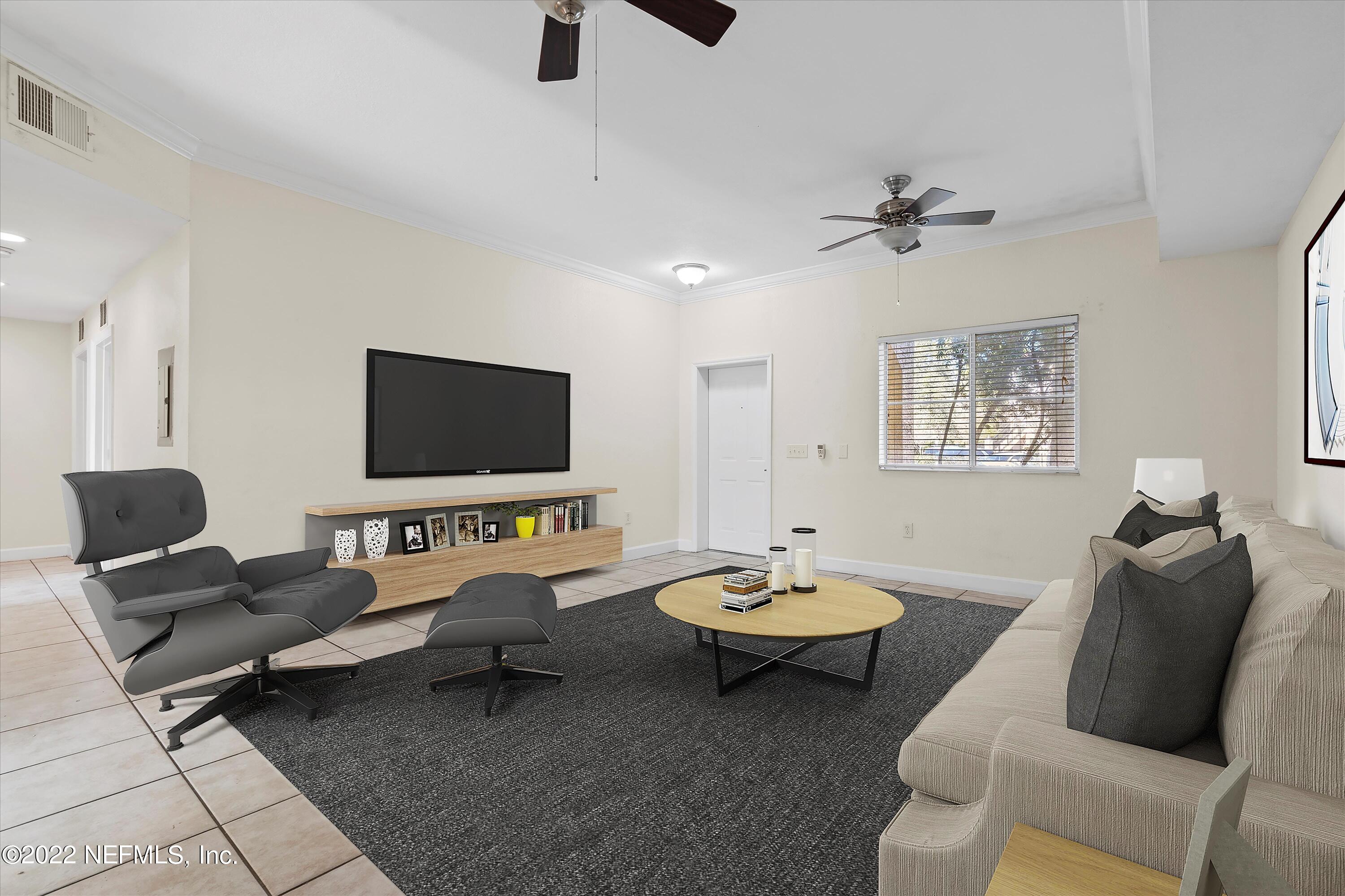 9745 Touchton Road, Unit 3203 Jacksonville, FL 32246 - Photo 2 of 30 a living room with furniture a flat screen tv and a window