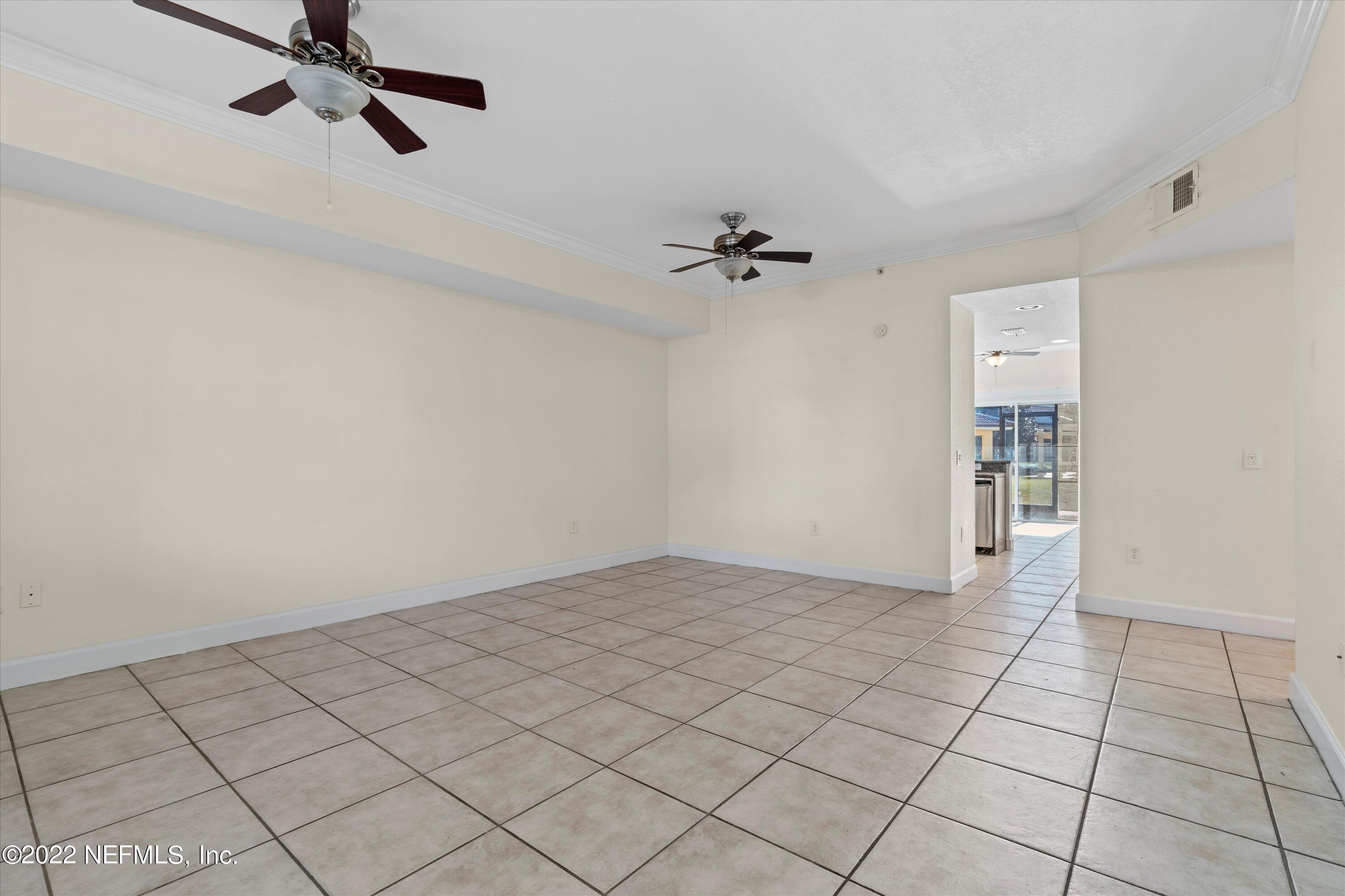 9745 Touchton Road, Unit 3203 Jacksonville, FL 32246 - Photo 4 of 30 a view of an empty room and chandelier fan