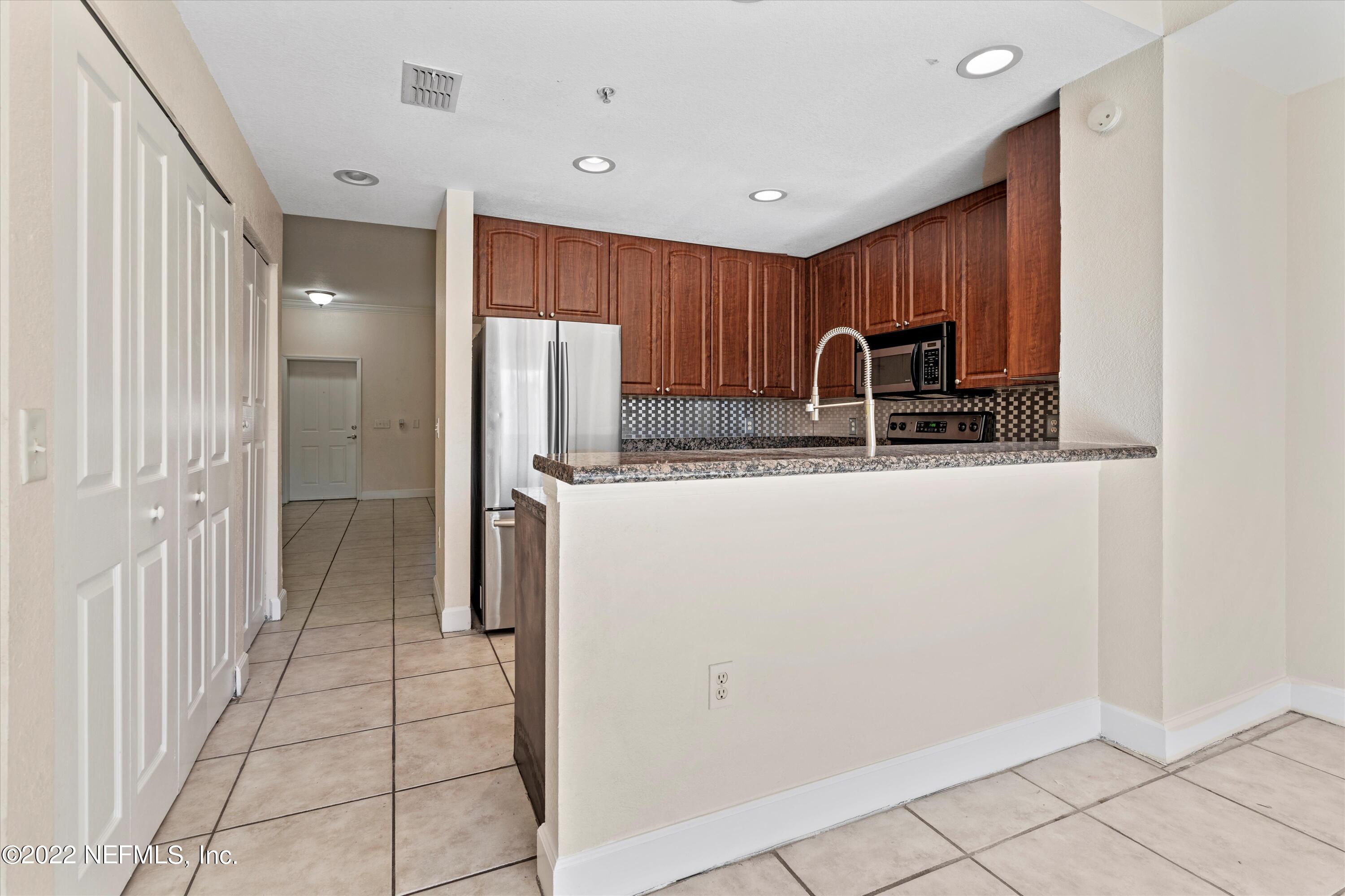 9745 Touchton Road, Unit 3203 Jacksonville, FL 32246 - Photo 7 of 30 a view of kitchen with a sink refrigerator and window
