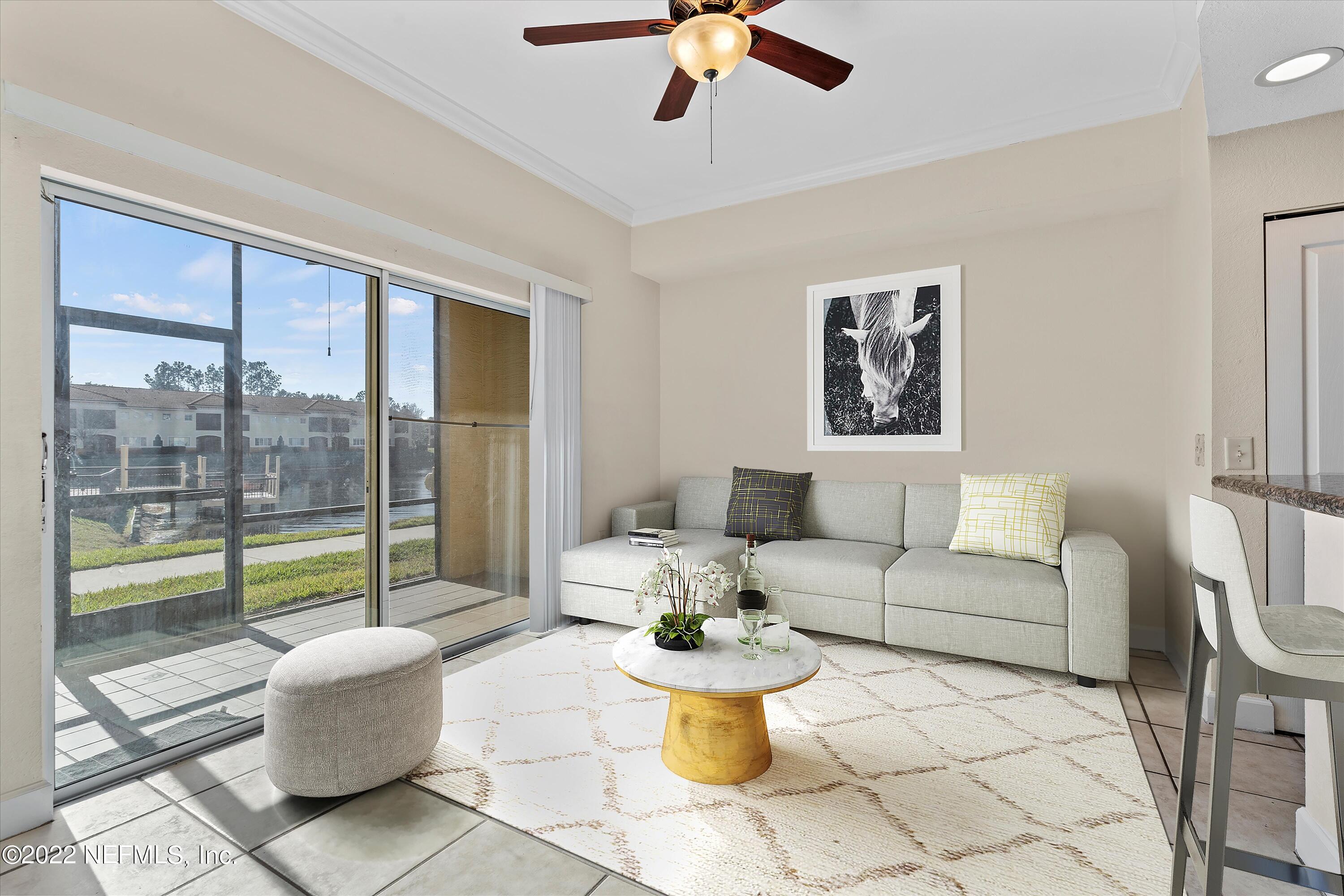 9745 Touchton Road, Unit 3203 Jacksonville, FL 32246 - Photo 9 of 30 a living room with furniture and a large window
