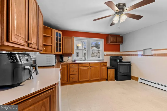 a kitchen with stainless steel appliances granite countertop a stove sink and cabinets